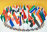 Fototapeta Boho - Flags of countries of world on negotiating table