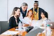 © jaimelafrickmartial  - Five colleagues of different ages multiethnic consultants discussing company financial strategy