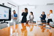 © jaimelafrickmartial  - Portrait of multi-ethnic business team cheering happily listening to value chart presentation on screen in mid meeting, copy space.