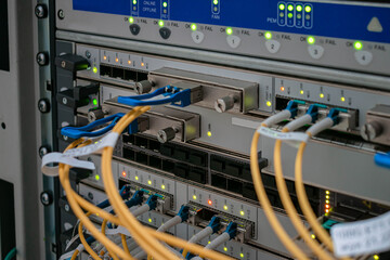 Modern switching equipment is in the server room of the Internet data center. The main fiber optic channels are connected to the interfaces of a powerful router.