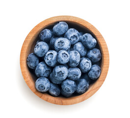 Wall Mural - Ripe blueberries in a wooden plate on a white background. Top view