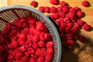 Sticker - Ripe red raspberries in a basket, village style