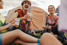 Young People Hanging Out Together At A Festival Camp, Enjoying Refreshing Beers And Moments Of Laughter