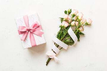 Wall Mural - design concept with pink rose flower and gift box on colored table background top view. Happy Holiday, Mothers day, birthday concept. Romantic flat lay composition