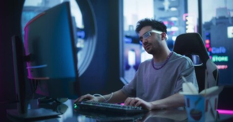 Creative Multiethnic Man Using Desktop Computer in a Futuristic High Tech Office Space. Young Handsome Man Wearing Advanced Device or Augmented Reality Glasses White Working Behind a Desk