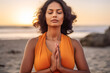 © JuanM - Close up of a hindi woman practicing meditation at the beach. Generative AI.