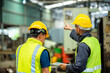 © BESTIMAGE - Two professional engineer worker technician assistant in helmet inspection check old machine construction factory with colleague manager. check old machinery production construction operating