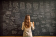© Ployker - young teacher write on chalk board. Woman writing on blackboard wall. Idea creative education teaching math and spelling letter, knowledge, back to school concept