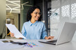 latin american businesswoman working inside office with documents and laptop, worker paperwork calculates financial indicators smiling and happy with success and results of achievement and work.