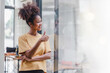 © PRIME STOCK LAB - Friendly, cheerful, and attractive African American woman with afro hair standing with her hands crossed over her chest.