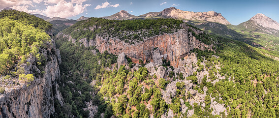 Wall Mural - Deep gorge of Red Kizil Canyon Kapuz in Turkey, Antalya city. Aerial view of scenic wild nature