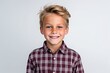 Portrait of a cute little boy with blond hair on a white background