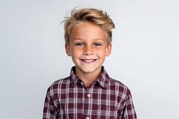Wall Mural - Portrait of a cute little boy with blond hair on a white background