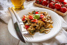 Dish of wholemeal pasta with Genoese pesto and cherry tomatoes