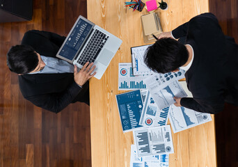 Poster - Top view analyst team discussing financial data on digital dashboard, analyzing chart and graph papers by data science software on wooden table background. Business intelligence and Fintech. Fervent