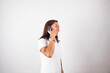 © artrolopzimages - photo of latin woman talking on the phone with gestures on a light background. Concept of people and emotions.