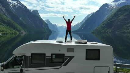 tourist feeling excited while enjoying beautiful norwegian landscape.