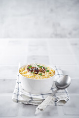 Wall Mural - Corn porridge with fried bacon, parsley and Feta cheese in a bowl