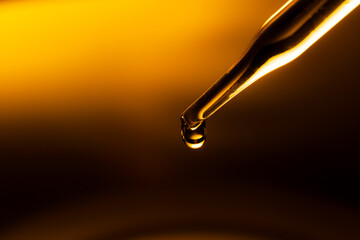 Wall Mural - yellow science test tube,dropping yellow chemical liquid or essential oil to test tube on white back