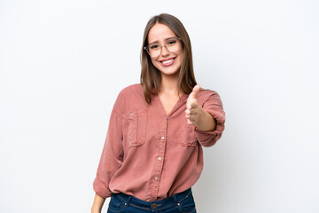 Wall Mural - Young pretty caucasian woman isolated on white background shaking hands for closing a good deal