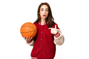 Canvas Print - Young basketball player woman over isolated chroma key background with surprise facial expression