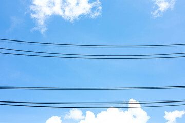 Wall Mural - power lines under clouds blue sky. electric cable stripes with a beautiful bright sky above the grou