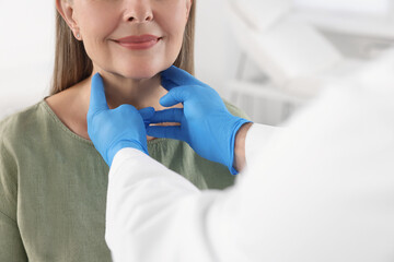 Poster - Endocrinologist examining thyroid gland of patient indoors, closeup