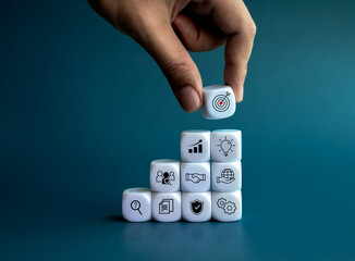 Poster - Goal and success with strategy icons. Hand put white block with target symbol on the top of growth graph steps with management elements on blue background. Business startup for Leadership concept.