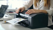 Businesswoman using printer at the office