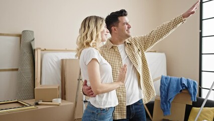 Poster - Man and woman couple hugging each other standing at new home