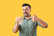 Young man with dissolved tablet and glass of water on yellow background
