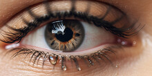 Close Up Of A Female Eye, Tearful Eye Capturing The Depths Of Sadness And Grief,  Closeup Of Crop Female With Blue Eye Limbal Ring And Black Eyelashes With Small Crystals
