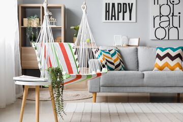 Wall Mural - Interior of stylish living room with striped hammock and grey sofa