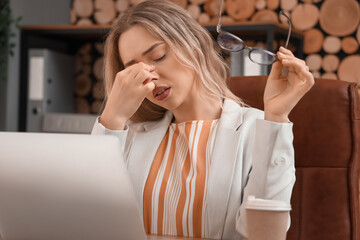 Poster - Tired businesswoman with stylish eyeglasses in office