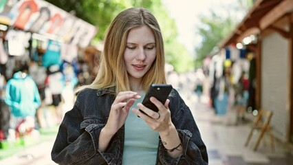 Sticker - Young blonde woman smiling confident making selfie by the smartphone at street market