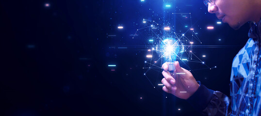 Poster - Young man holding a bright light bulb inspiration for the development of creative ideas or new imaginations. polygons connected Variety of brainstorming concepts on dark blue background.