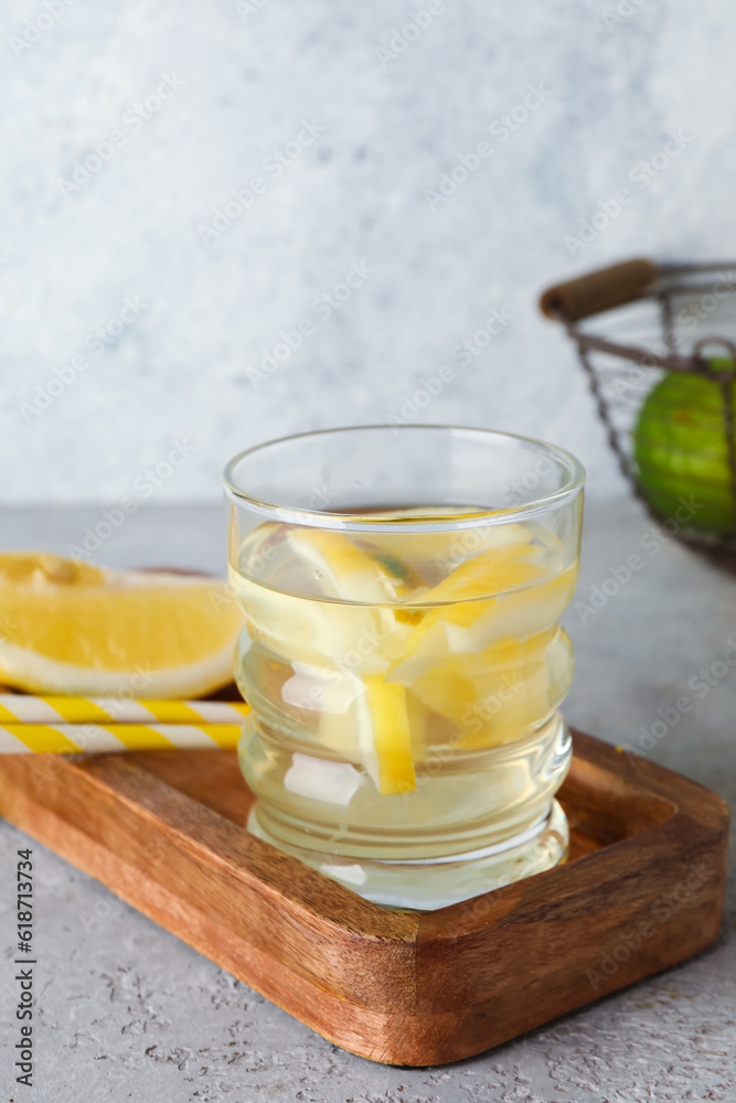 Glass of infused water with lemon on table
