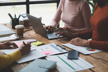 Wall Mural - business woman Finance Audit Administrator and secretary making reports, brainstorming, taking notes, researching on laptop on business growth data and pointing out accounting financial charts.