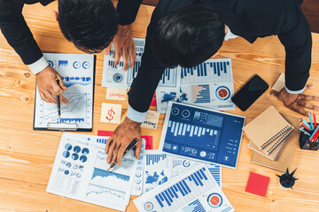 Poster - Top view analyst team discussing financial data on digital dashboard, analyzing chart and graph papers by data science software on wooden table background. Business intelligence and Fintech. Fervent