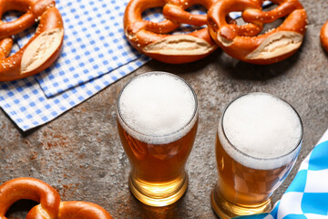 Flag of Bavaria, mugs with beer and pretzels on dark background