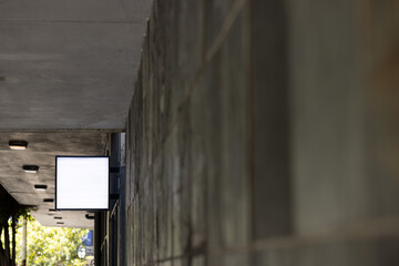 Canvas Print - Blank sign fixed to building wall with copy space