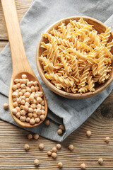 Wall Mural - Chickpea bean fusilli pasta on a old wooden background.