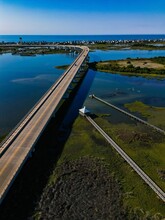 Aerial Shot Of A Massive Bridge On A River On A Sunny Day In Surf City, NC