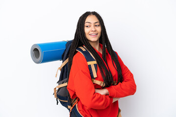 Wall Mural - Hiker teenager girl with braids over isolated white background with arms crossed and happy