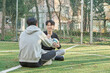 © TEAM PRE-LIGHT - Two young male college models sitting on a university futsal field in South Korea, Asia, chatting after the game