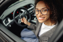 Young Smiling Woman Holding Keys To Rental Car Before Trip And Smiling At Camera
