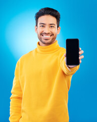 Poster - Advertising, portrait of man with smartphone and in blue background happy for social networking. Online communication, technology or marketing, branding and male person with cellphone app in studio