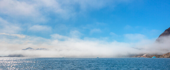 Wall Mural - arctic landscape of greenland in summer. beautiful view of mountains with snowy peaks and iceberg