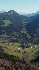 Canvas Print - Aerial of a small camp surrounded by big mountains and dense forests