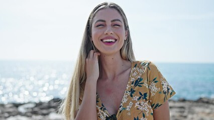 Sticker - Young blonde woman smiling confident standing at seaside